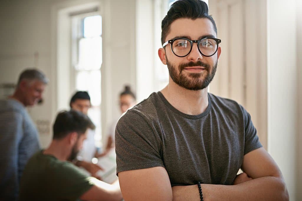 portrait of a confident young man leading a team of creatives